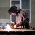 man works welding machine